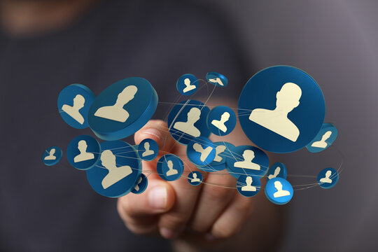 A hand touching a network of user icons, symbolizing social connection, digital communication, and team collaboration online.