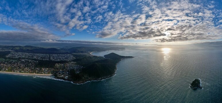 Lake landscape with dramatic clouds and golden sunset light - Powered by Adobe