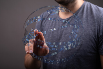 A man's hand interacting with a holographic data sphere, representing technology, future, and digital transformation. Modern concept