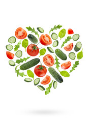 Organic vegetable salad ingredients as heart shape, isolated. Red tomatoes, green cucumbers, mixed greens levitation in art composition. Vegetarian diet food, detox cooking, fitness diet, advertising.