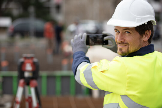 surveyor taking site photograph with a smartphone