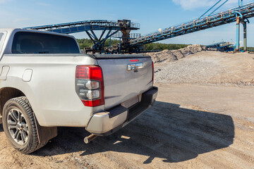 Bright sunlight illuminates open industrial potassium mining site blue conveyor structures  silver...