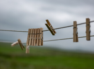 old and wooden clothespins on a rope