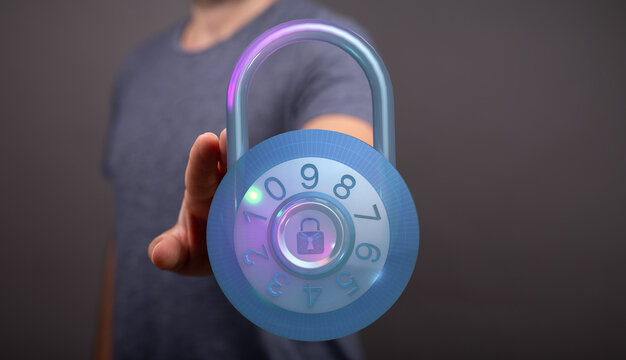 A close-up of a person's hand reaching for a digital padlock with a glowing interface and combination display. Concept of security an