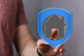 Close up of a hand interacting with a digital home icon, conceptualizing real estate, property, and investments. Modern technology in home buyin