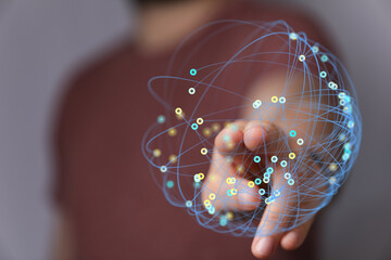 Close-up of hand touching a digital globe network representing global connection and technology concept. Illustrating worldwide network.