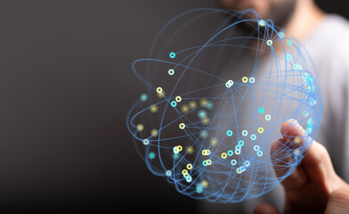 Close-up of a hand holding a glowing digital globe representing global connections and networks....