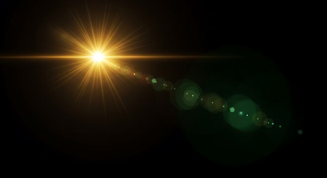 Bright golden sunburst lens flare with bokeh effect on a black background, abstract light photography