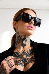 Bold woman with striking tattoos and oversized sunglasses exudes modern confidence and edgy style, perfect for fashion and lifestyle campaigns