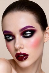 Stunning model showcases dramatic avant garde makeup with bold plum brows and glossy dark lips, radiating confidence and high fashion allure.