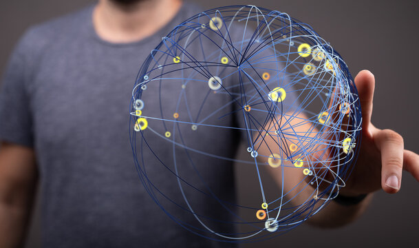 A man's hand touching a digital world globe representing global communication, networks, and the future. Visual representation of tec