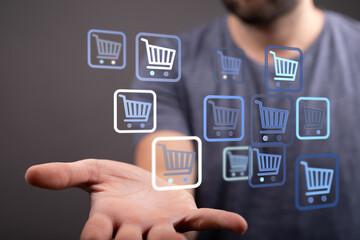 Hand offering shopping cart icons representing online shopping, e-commerce, and digital retail. Perfect for illustrating buying, sales, and onli