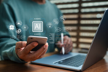 Businessman using smartphone and laptop with AI agent icons, representing artificial intelligence technology, automation, digital transformation, and smart solutions for modern business innovation.