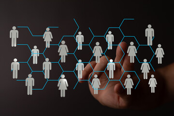 Abstract network of people icons interacting with a human hand representing communication and...