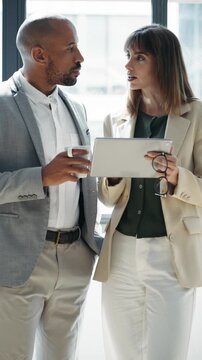 Video of business people working with digital tablet while discussing together in conference room at modern startup