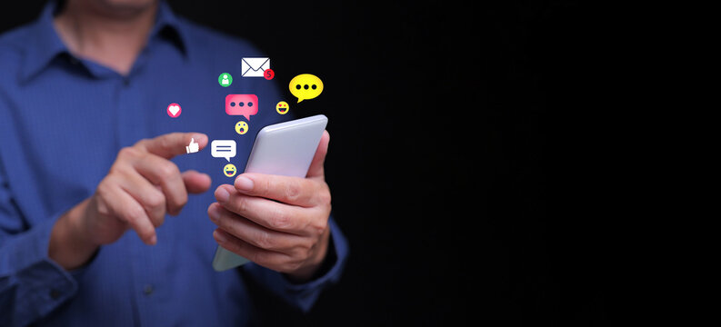 Person using smartphone with colorful chat bubbles, emojis, and social icons, representing online communication, chat and messaging, and digital interaction.