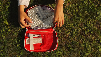 First aid kit. first aid kit and green lawn. Open first aid kit. High quality photo.