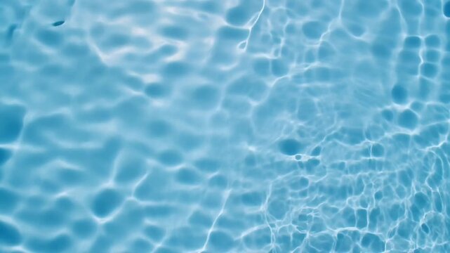Close-up of shimmering blue water surface with gentle ripples and light reflections creating a calming and refreshing abstract pattern
