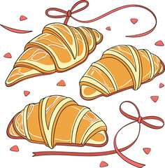 Three croissants with ribbons and rose petals