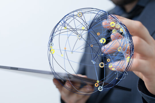 A close-up of a businessman holding a digital global sphere with connections, representing technology, networking, and global busines