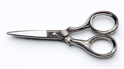 Fototapeta premium A pair of shiny metal scissors with rounded handles on a white background close up