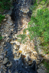 Stunning aerial view of a river flowing through lush greenery in Purace, Cauca, Colombia, showcasing nature's beauty.