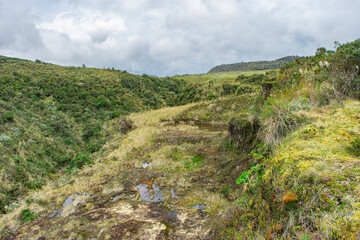 A serene view of the lush hills and valleys in Purace, Cauca, Colombia, showcasing rich biodiversity and natural beauty.