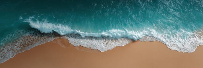 Stunning aerial view of ocean waves crashing on sandy beach