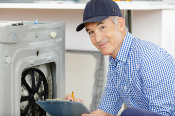 a plumber repairing washing machine