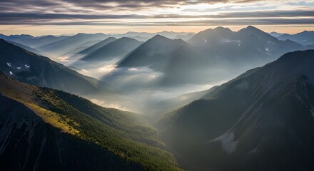 Aerial view of mountain range covered with fog during sunrise in banff, canada