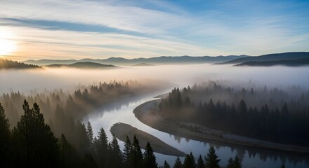 Foggy river winds through a forest at sunrise in the mountains of montana
