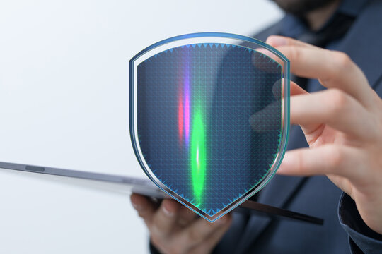 A businessperson in a suit interacting with a digital shield representing security and data protection. Represents internet safety, b