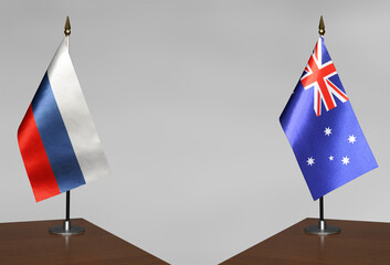 Table flags Russia and on Australia grey blurred background