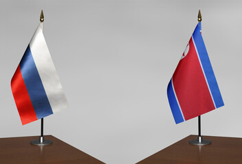 Table flags Russia and North Korea on grey blurred background