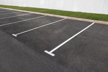 parking with asphalt surface and markings for cars.