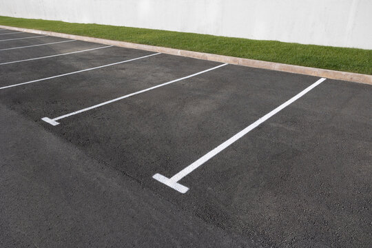 parking with asphalt surface and markings for cars.