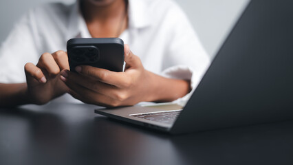 Business Person Using Smartphone and Laptop for Online Communication
