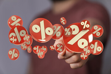 Hand holding red percentage symbols, perfect for sales, discounts, promotions, and financial...