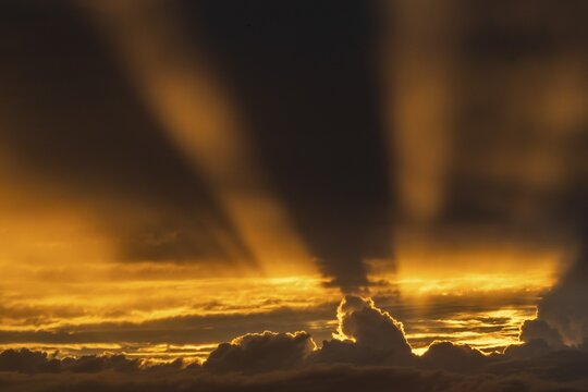 Rays of sunshine penetrate from behind storm clouds, dramatic lighting mood, Germany