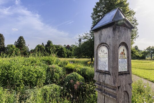 Old wooden information board in front of Schlehdorf Monastery, Schlehdorf, spring, sunny, Bavaria, Germany