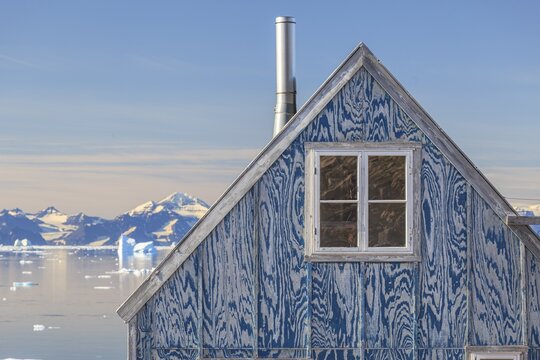 Typical Greenlandic house in an Inuit settlement on a fjord off Bergen, sunny, Ittoqqortoormiit, Scoresby Sund, East Greenland, Greenland