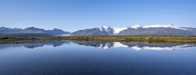 Reflection in a lake, view of Svínafellskökull glacier tongue, glaciated mountain peak Hrútfjallstindar, Vatnajökull National Park, Austurland, Iceland