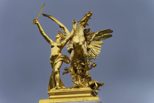 Column with the group of figures Fama in battle on the Pont Alexandre III bridge over the Seine, Paris, France