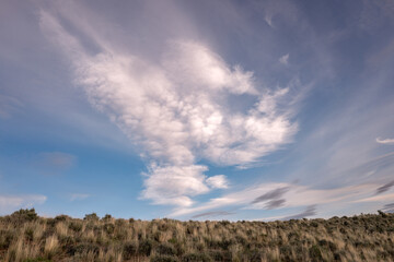 Clouds and blue sky over a desert landscape