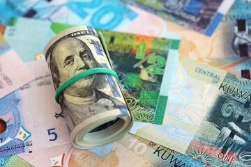 Kuwaiti dinar currency money bills and bunch of us dollar banknotes close up. The concept of...