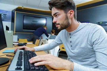 student using desktop computer in classroom