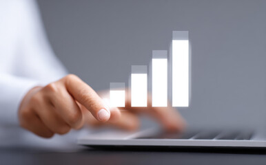 Focused business person using technology for finance data analysis. Touching virtual growth chart and graph showing success, illustrating positive business strategy