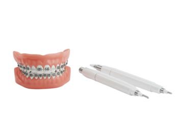 Traditional metal braces and sleek tooth whitening pens arranged on a transparent studio background with copy space, high-key lighting for advanced dental aesthetics concept.
