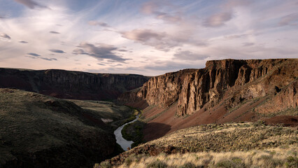 Sunset over the Owyhee River with rock cliffs