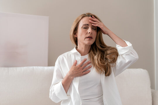 Mature woman experiences panic attack with chest pain and breathing difficulties